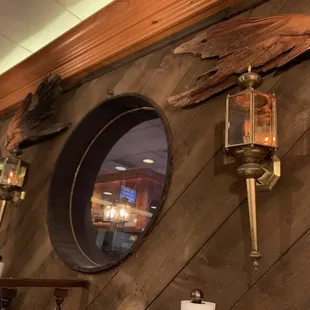 a wooden wall with three round mirrors