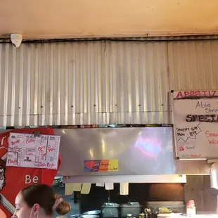 Filthy HVAC vent directly over where prepared food is left for waiters to pick up.