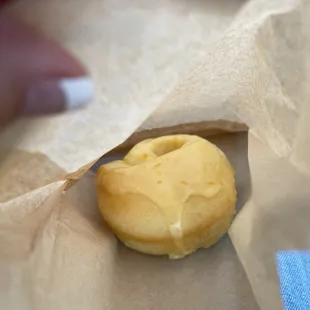 a donut in a brown paper bag