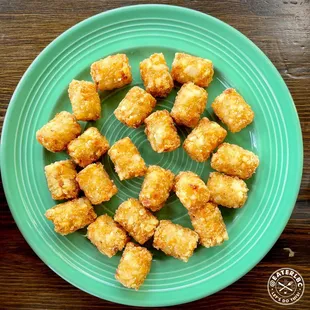 fried tater tots on a green plate