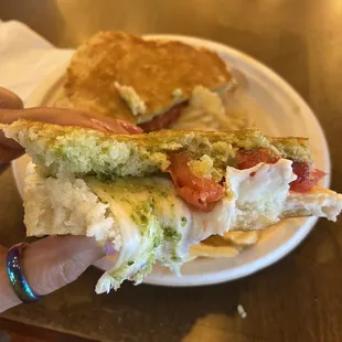 a hand holding a sandwich