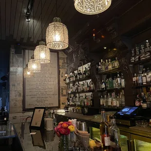 a bar with bottles of alcohol on the counter