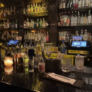 a bar with liquor bottles and glasses
