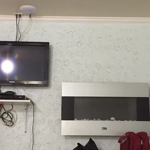 Tv and what I think is a wall mounted fire place!