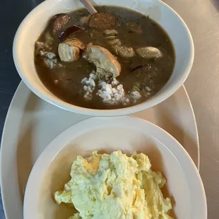 a bowl of soup and a plate of mashed potatoes