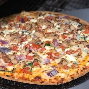 a pizza cooking on a grill