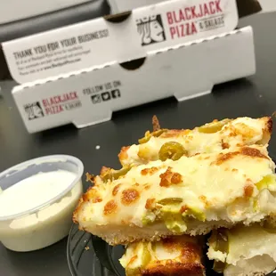 a slice of pizza with cheese and olives