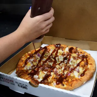 a hand holding a bottle of ketchup