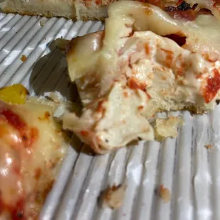 a half eaten pizza on a plate