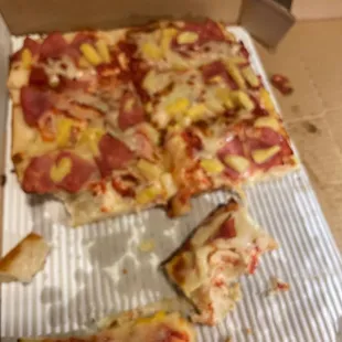 a pizza with pineapple and ham