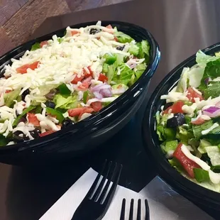 two bowls of salad and a fork