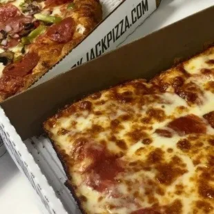 two pizzas in boxes