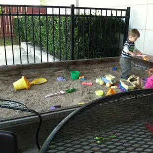 Playing in the sandbox. Keeps the kids entertained.
