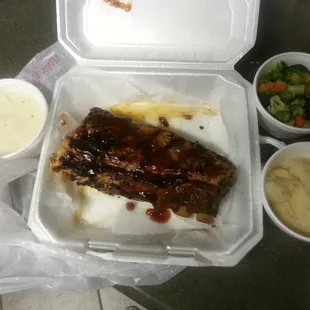 Half slab of ribs, mashed potatoes, steamed veggies and gravy