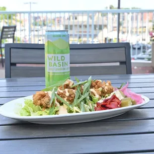 a plate of salad and a drink