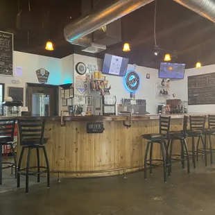 a bar with stools and tables