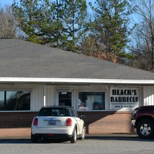 two cars parked in front of a restaurant