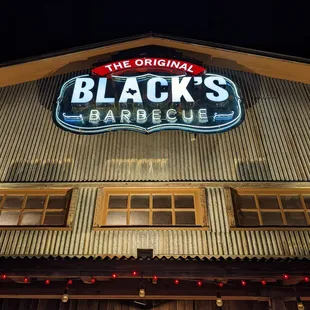 The sign outside at night.