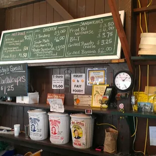 a shelf of items and a chalkboard
