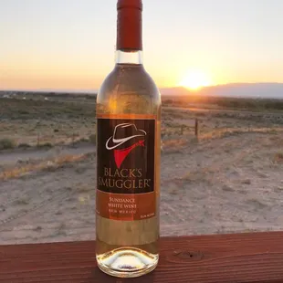 a bottle of wine on a wooden table