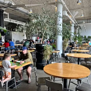 a woman and a child sitting at tables