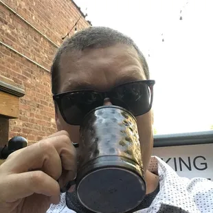 a man drinking from a mug