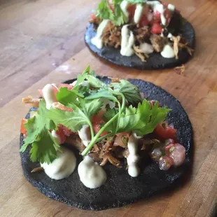 two tacos on a wooden table