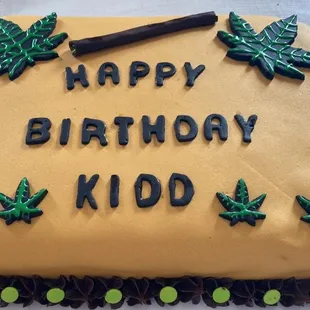 1/2 sheet chocolate cake with homemade buttercream frosting decorated with fondant decorations and lettering