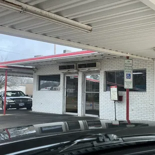 a car parked in front of a gas station