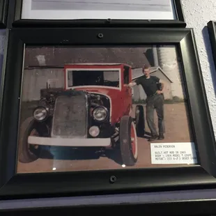 a picture of a man standing next to a car