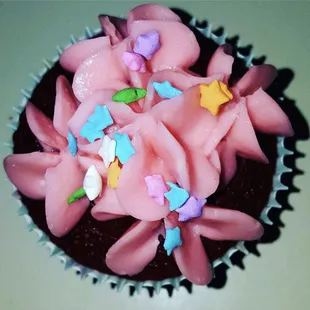 a chocolate cupcake with pink frosting