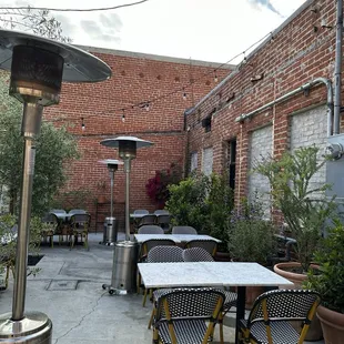 a patio with tables and chairs