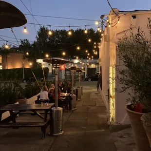 a patio with tables and umbrellas