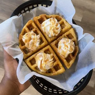 Sweet potato waffle featuring whip cream and caramel drizzle.
