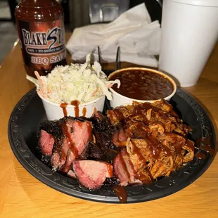 a plate of ribs and coleslaw