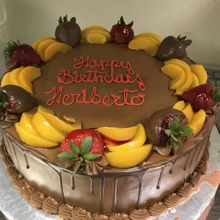 a chocolate cake decorated with fruit