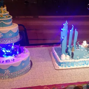 two tiered cakes decorated with blue frosting