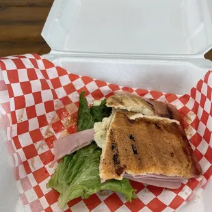 a sandwich in a styrofoam container