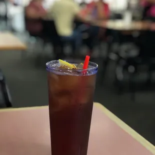 a glass of iced tea on a table