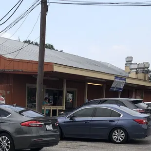 two cars parked in front of a restaurant