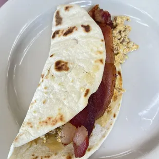 Breakfast tacos , chorizo , egg and added in a strip of bacon
