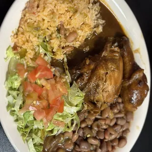 Chicken Mole, rice, beans and salad.