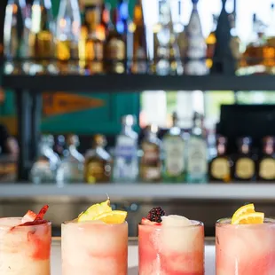 a row of cocktails