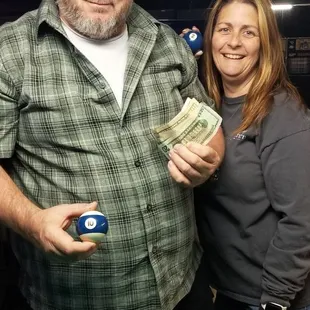 a man holding a billiards bill