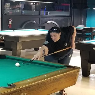 a woman playing pool