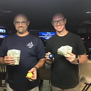 two men holding billiards