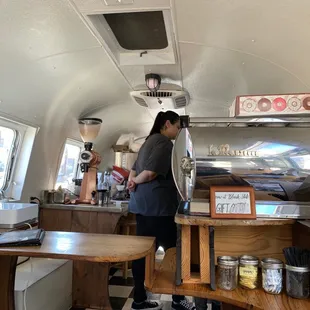 a woman standing in a coffee shop