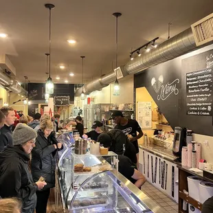 a crowd of people in a bakery