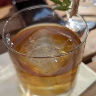 a glass of beverage on a table