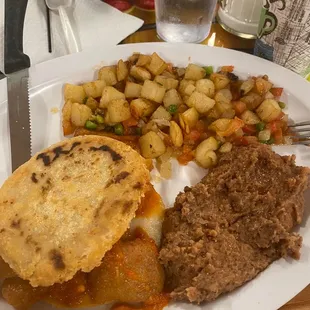 They made me this custom breakfast for me. Gordita de chicharrón en salsa roja. With some extra refried beans and papa a la Mexican.